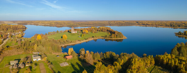 Majestic landscape photographed by drone. Aerial view of freshwater lake with island. Image for design and background.