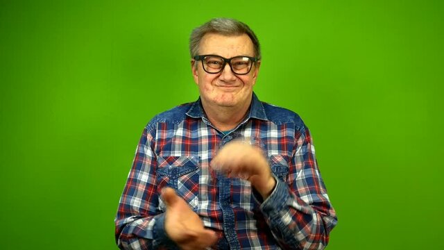 Mature adult strange man in stupid glasses is emotionally claps his hands.