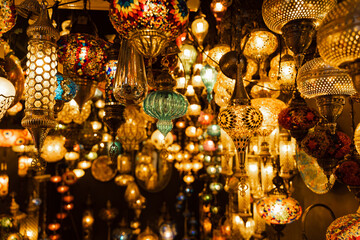 Assortment of lanterns mosaic lamps and oriental traditional lamps hanging in market Turkey.
