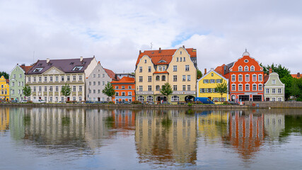 Fototapeta na wymiar City buildings reflecting in water, Landshut, Germany