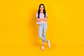 Fototapeta na wymiar Full length photo of young preteen girl happy positive smile confident folded hands isolated over yellow color background