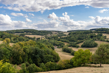 Fototapeta premium A picturesque landscape in Autun, France, showcasing the natural beauty of the region with rolling hills and lush greenery.
