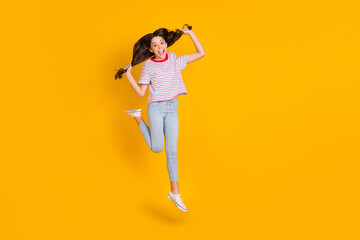 Fototapeta na wymiar Full body photo of young excited girl happy positive smile crazy jump up yell isolated over yellow color background