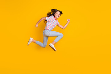 Fototapeta na wymiar Full body profile side photo of young excited girl happy smile jump up run hurry sale isolated over yellow color background
