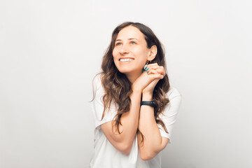 Portrait of cute young woman looking away over white background.