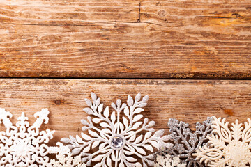 Border from snowflakes on an old wooden background.