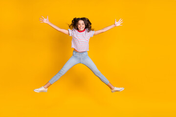 Fototapeta na wymiar Full body photo of young cheerful girl happy positive smile have fun jump up isolated over yellow color background