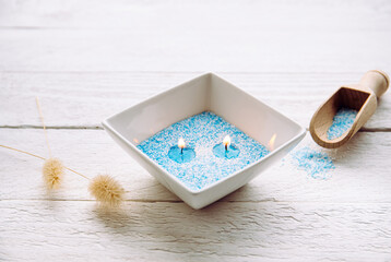Blue and white granulated wax crystals to create candles by pouring in bowl and inserting wick....