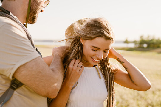 White couple smiling while hiking together outdoors