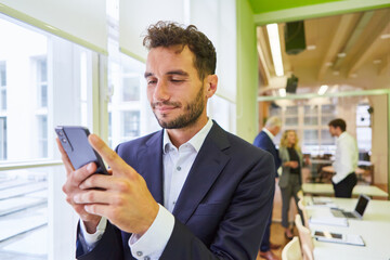 Fototapeta na wymiar Business man using smartphone during video chat