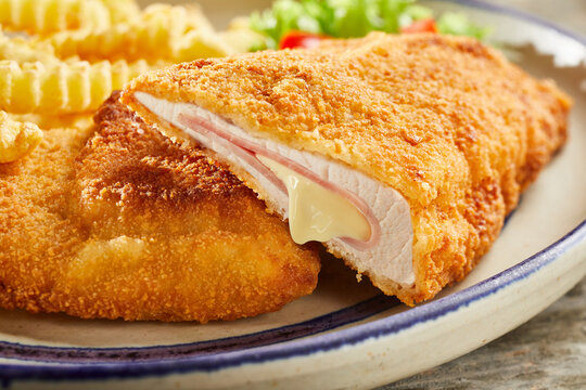 Tasty cordon bleu with cheese on plate