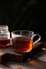 Cup of black tea on a wooden table