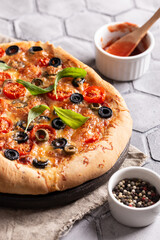 Freshly baked pizza on a wooden board