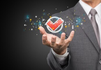 Businessman hand shows the sign of the service Quality assurance, Guarantee, warranty, Social Responsibility Standard Certified