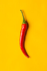 Chilli on yellow background with copy space