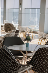 An empty cafeteria interior shot. Large windows letting in light.