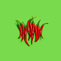 Chilli peppers on green background with copy space