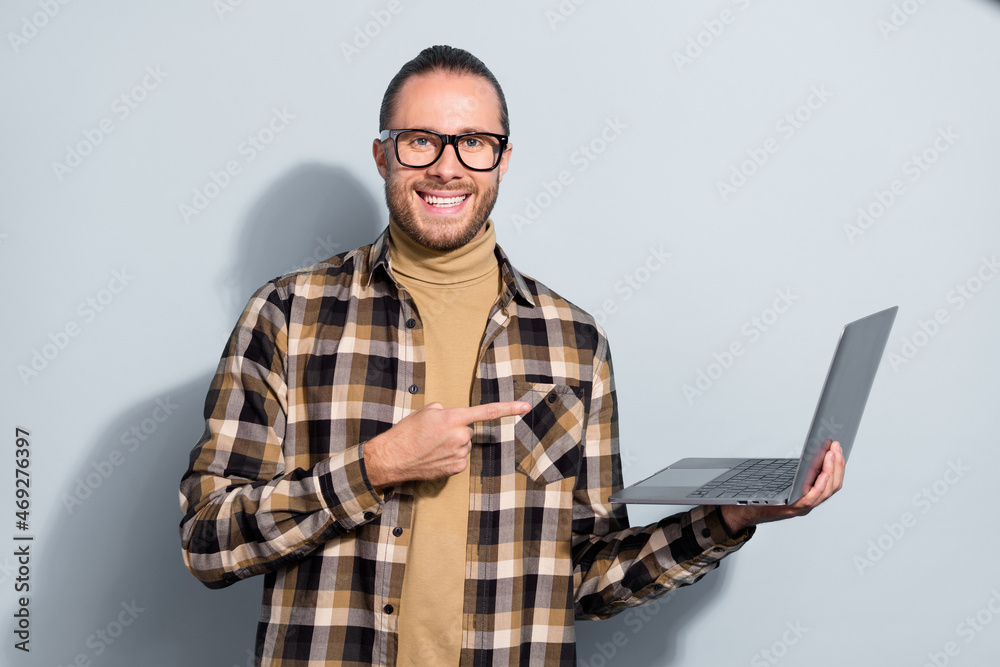 Sticker Photo of young handsome guy indicate finger laptop advise recommendation isolated over grey color background