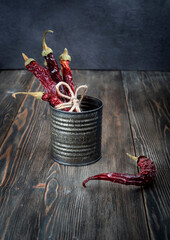 Dried hot red pepper on a dark wooden background