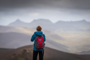 Hiking adventures young girl in Icelands highlands.