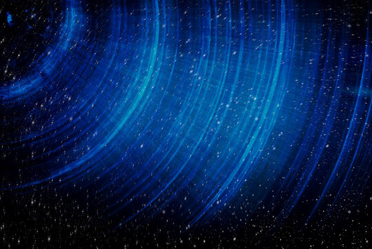 Blue abstract background with spiral pattern. Galaxies with stars and planets with circular motifs in deep blue lines of the universe night light space. No render.