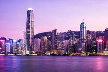 Hong Kong skyline cityscape downtown skyscrapers over Victoria Harbour in the dusk.