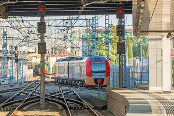 Train passing a railroad crossing. Dutch signs warning not go and red lights flashing.