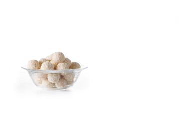 Homemade coconut balls in crystal bowl isolated on white background