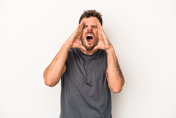 Young caucasian man isolated on white background shouting excited to front.