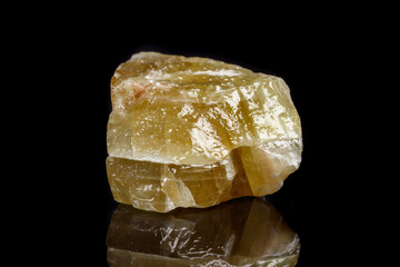 Macro mineral stone yellow Calcite on a black background