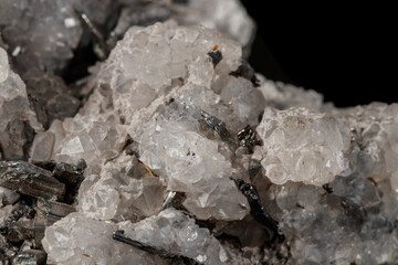 Macro mineral stone Stibnite quartz on a black background