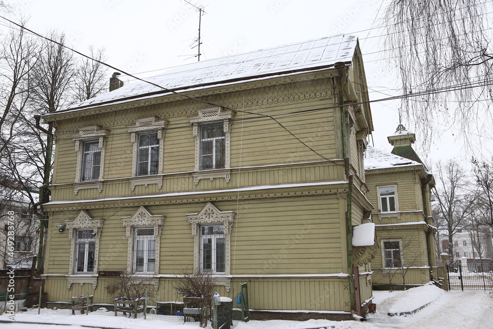 Wall mural Wooden house with ornamental windows, carved frames of merchant Sapozhnikov on Simanovsky Street, 14 (Sverdlova, 63), Kostroma city, Russia. Russian architecture