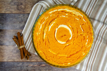 Pumpkin and cottage cheese casserole. round pumpkin diet pie, against a background of wooden table