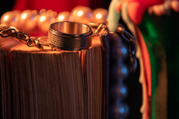 silver ring on a book on a dark background