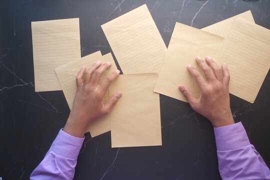 top view of young msn hand on blank paper on table 