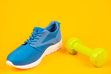 footwear for training with barbell on yellow background, sportswear