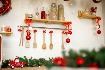 Kitchen wooden countertop with hob and kitchenware decorated for winter holidays new year christmas