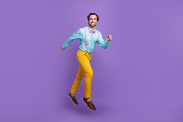 Fototapeta na wymiar Full body photo of cute young guy run wear tie suspenders shirt pants shoes isolated on purple background