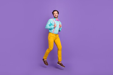 Fototapeta na wymiar Full body photo of funky young guy run wear tie suspenders shirt trousers footwear isolated on purple background