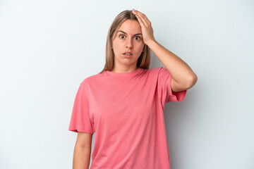 Young caucasian woman isolated on blue background being shocked, she has remembered important meeting.