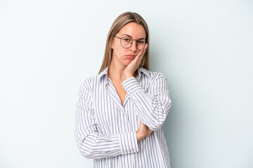 Young caucasian woman isolated on blue background who is bored, fatigued and need a relax day.