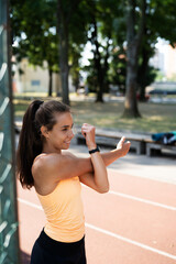 Beautiful athlete woman in sportswear outdoors. Young woman training in the park. Healthy lifestyle..