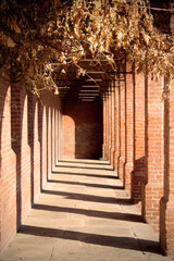 Red brick colonnade at sunset