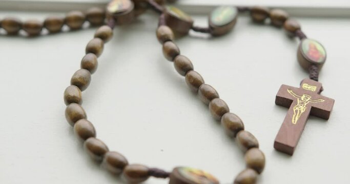 Close Up Quick Tilt Down of Wooden Rosary Beads