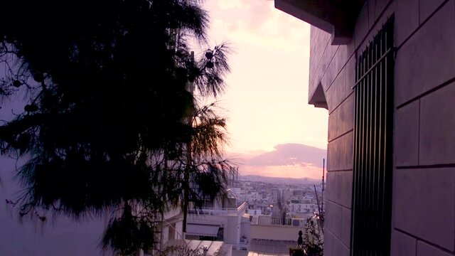 The city skyline of Athens, Greece, through buildings.
