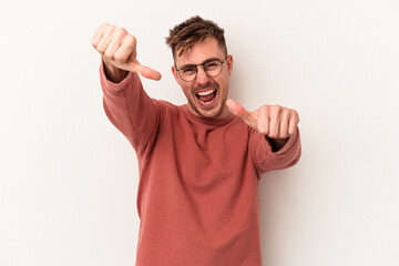 Fototapeta premium Young caucasian man isolated on white background raising both thumbs up, smiling and confident.