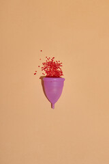 Menstrual cup on color background. Alternative feminine hygiene product during the period. Women health concept. Copy space. Eco friendly concept, zero waste product. Flat lay, mockup, template