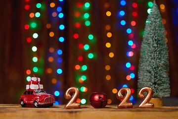 Holiday background  Numbers of year 2022 made by gold candles on bokeh festive sparkling background. celebrating New Year holiday, close-up. Space for text