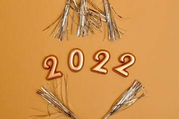 Holiday background  Numbers of year 2022 made by gold candles on bokeh festive sparkling background. celebrating New Year holiday, close-up. Space for text