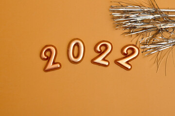 Holiday background  Numbers of year 2022 made by gold candles on bokeh festive sparkling background. celebrating New Year holiday, close-up. Space for text